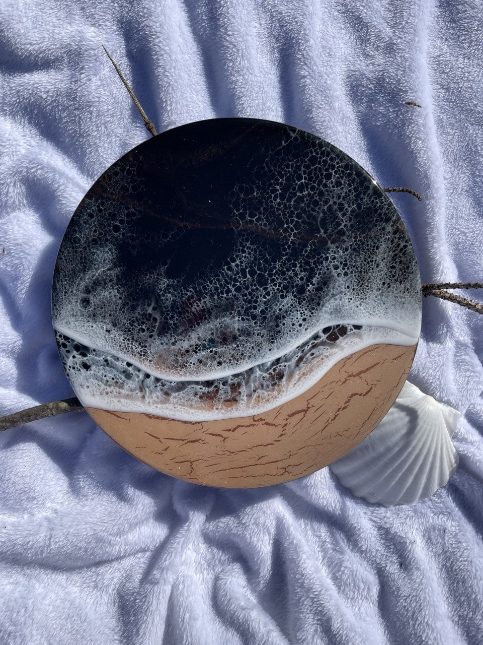 Moody black resin ocean and waves with shimmering copper beach