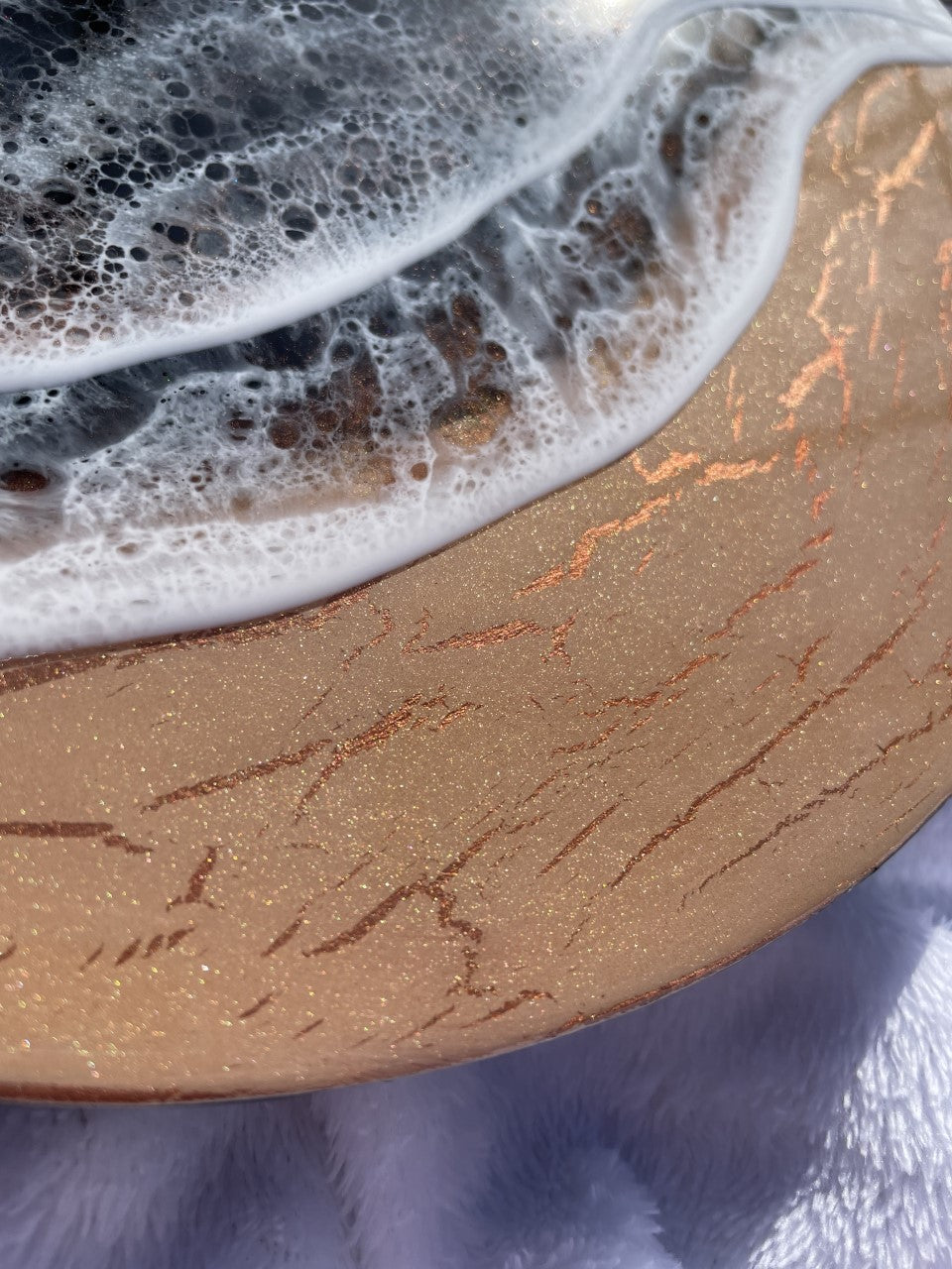 Moody black resin ocean and waves with shimmering copper beach