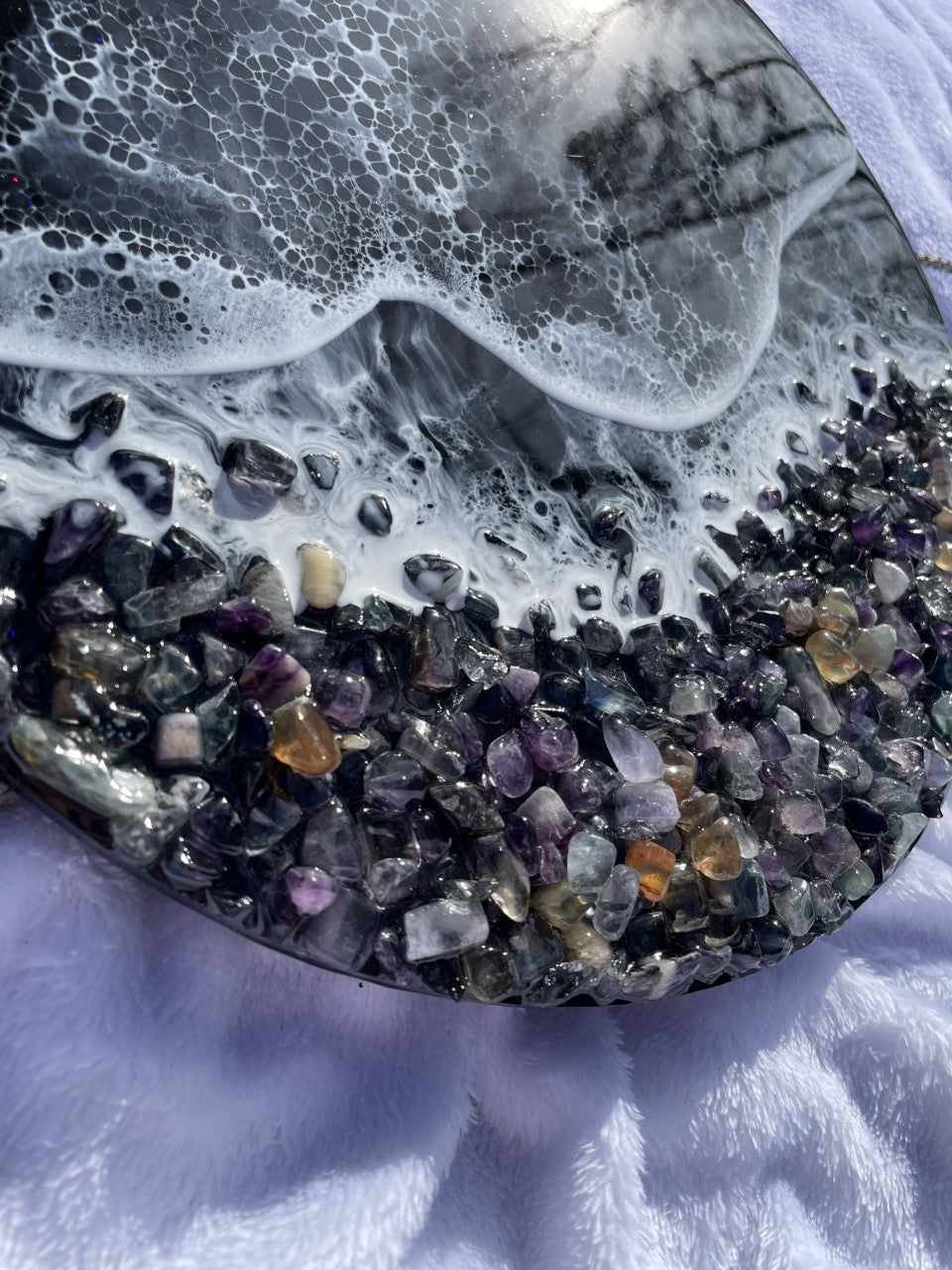 Black resin ocean with waves and rocky shore