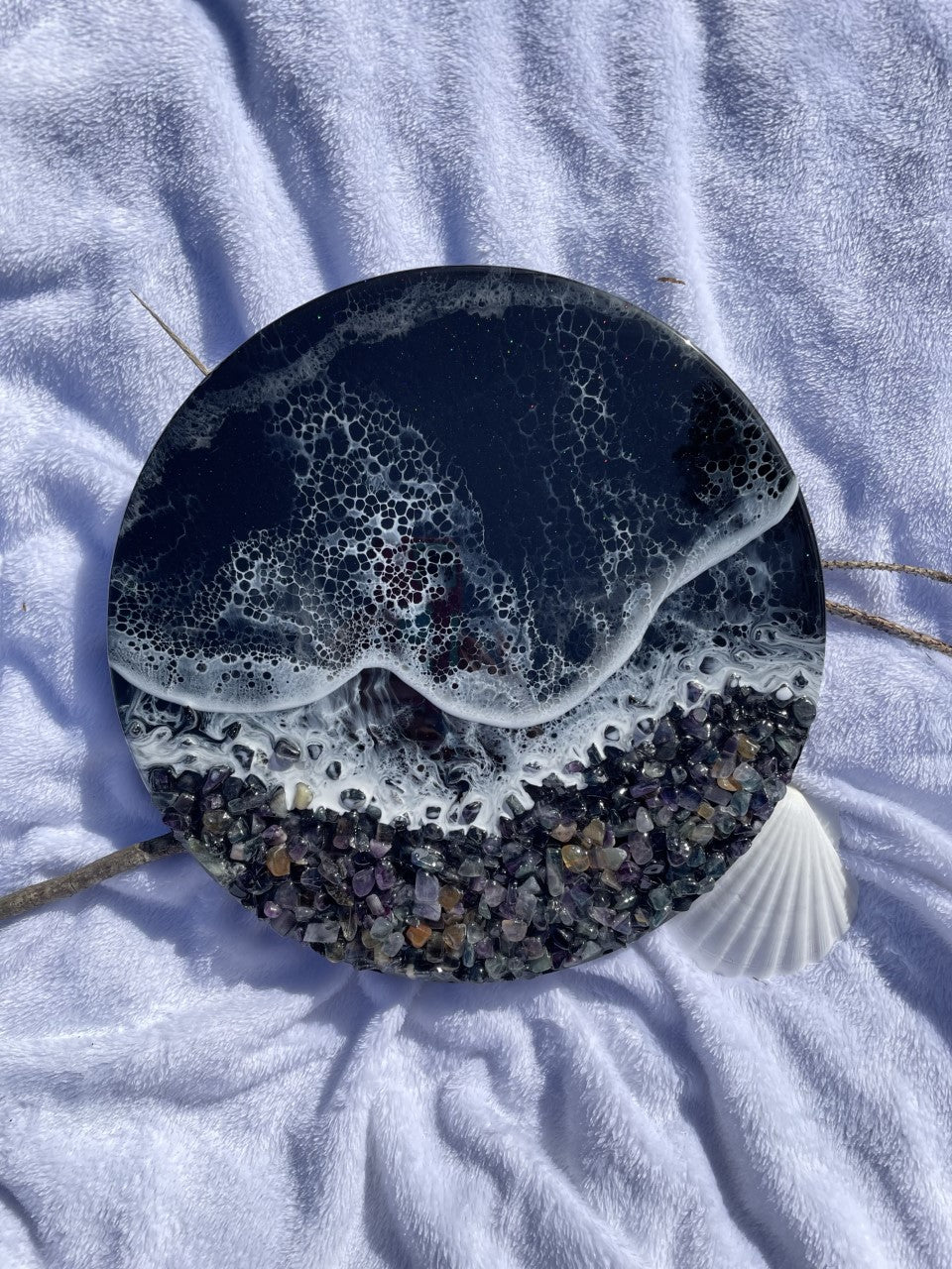 Black resin ocean with waves and rocky shore